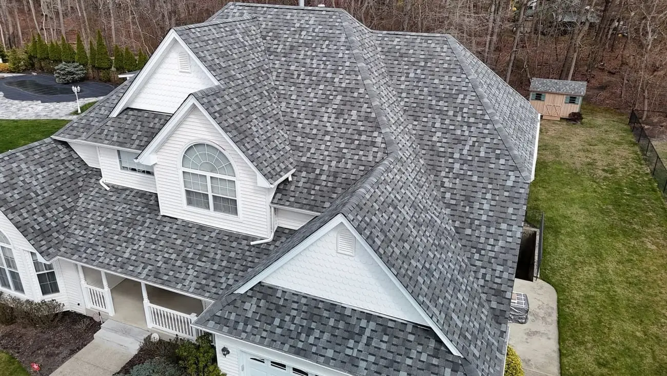 Aerial view of a two storey house with its new architectural shingle roof finished